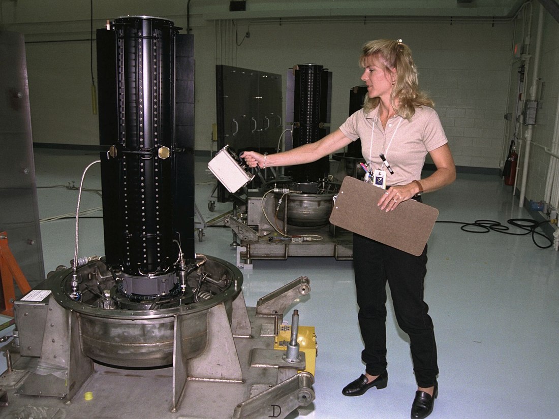 Radiation protection technician manually surveying nuclear equipment